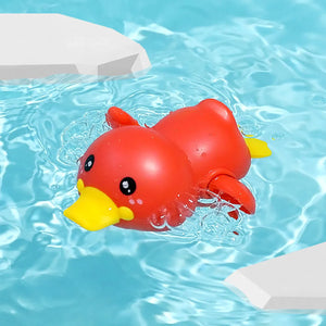 Red rubber duck floating in a pool with blue water.
