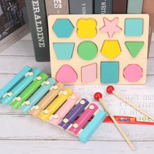 Load image into Gallery viewer, Colorful wooden toy set with shape sorter and xylophone on a wooden surface.