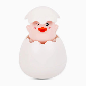 Cartoonish baby chick emerging from an egg on a white background