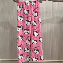 Load image into Gallery viewer, Pink &#39;Hello Kitty&#39; patterned pants held up against a neutral background