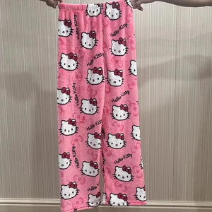 Pink 'Hello Kitty' patterned pants held up against a neutral background
