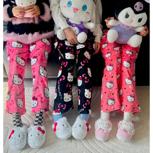 Three pairs of pajama pants with Hello Kitty design on a neutral background
