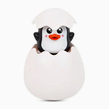 Load image into Gallery viewer, Penguin toy peeking out from a white egg on a white background