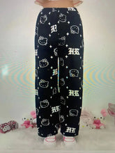 Load image into Gallery viewer, Black pants with white patterns on a white background