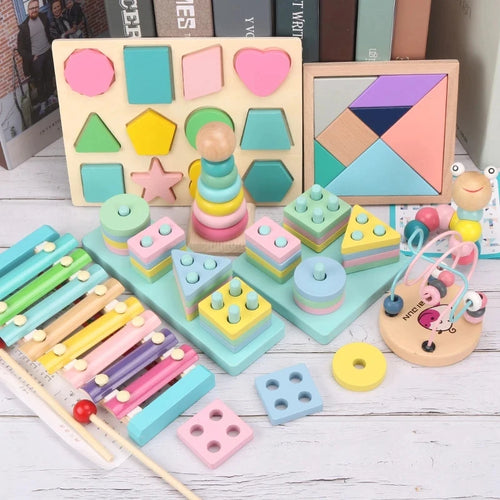 Assorted colorful wooden toys on a wooden surface with books in the background