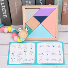 Load image into Gallery viewer, Wooden tangram puzzle with colorful geometric shapes on a wooden surface, surrounded by books and a toy.